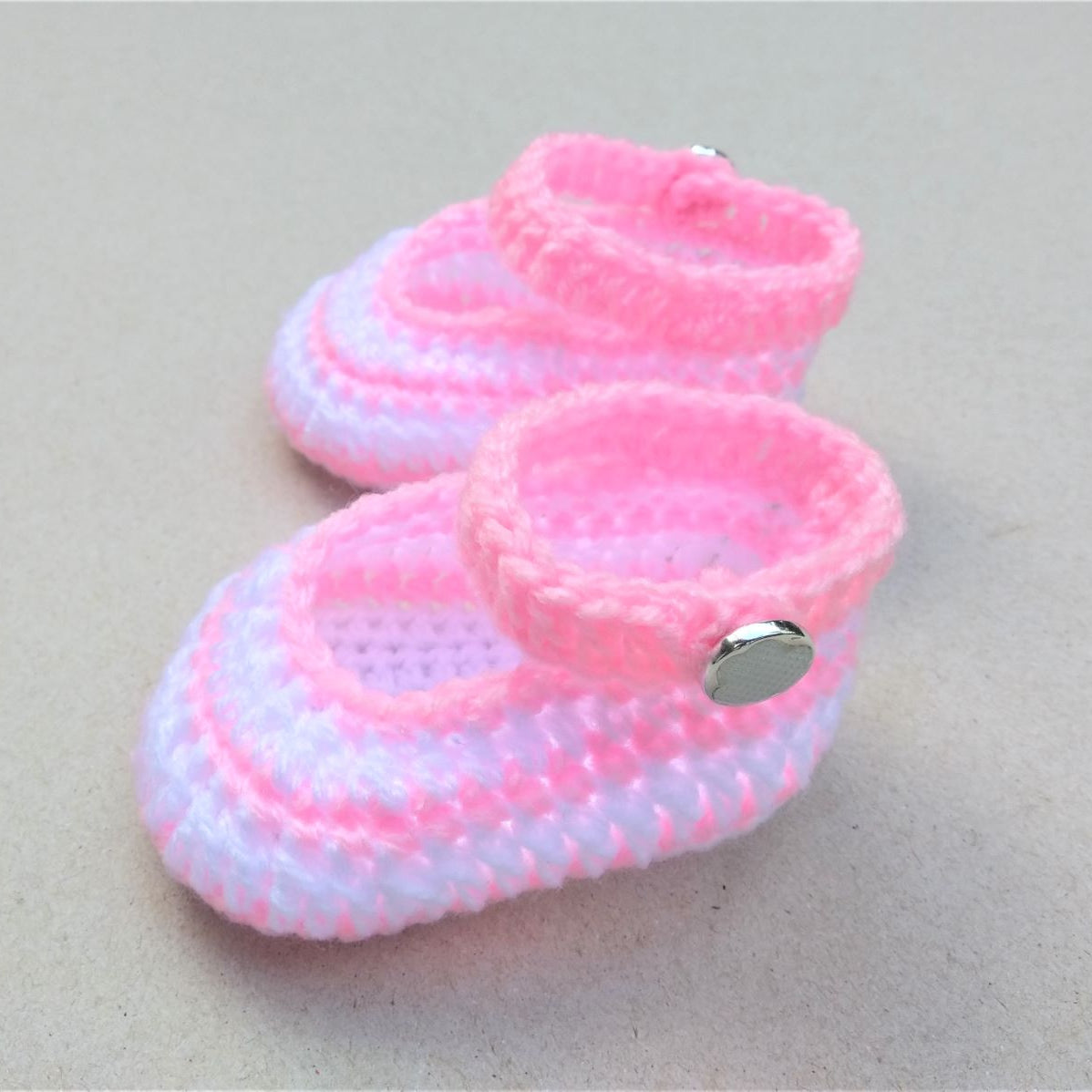 crochet baby shoes in light pink and white