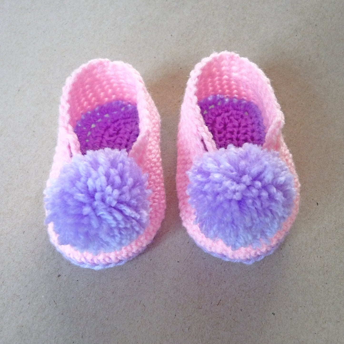 crochet baby shoes with pompoms for girls, pink and purple