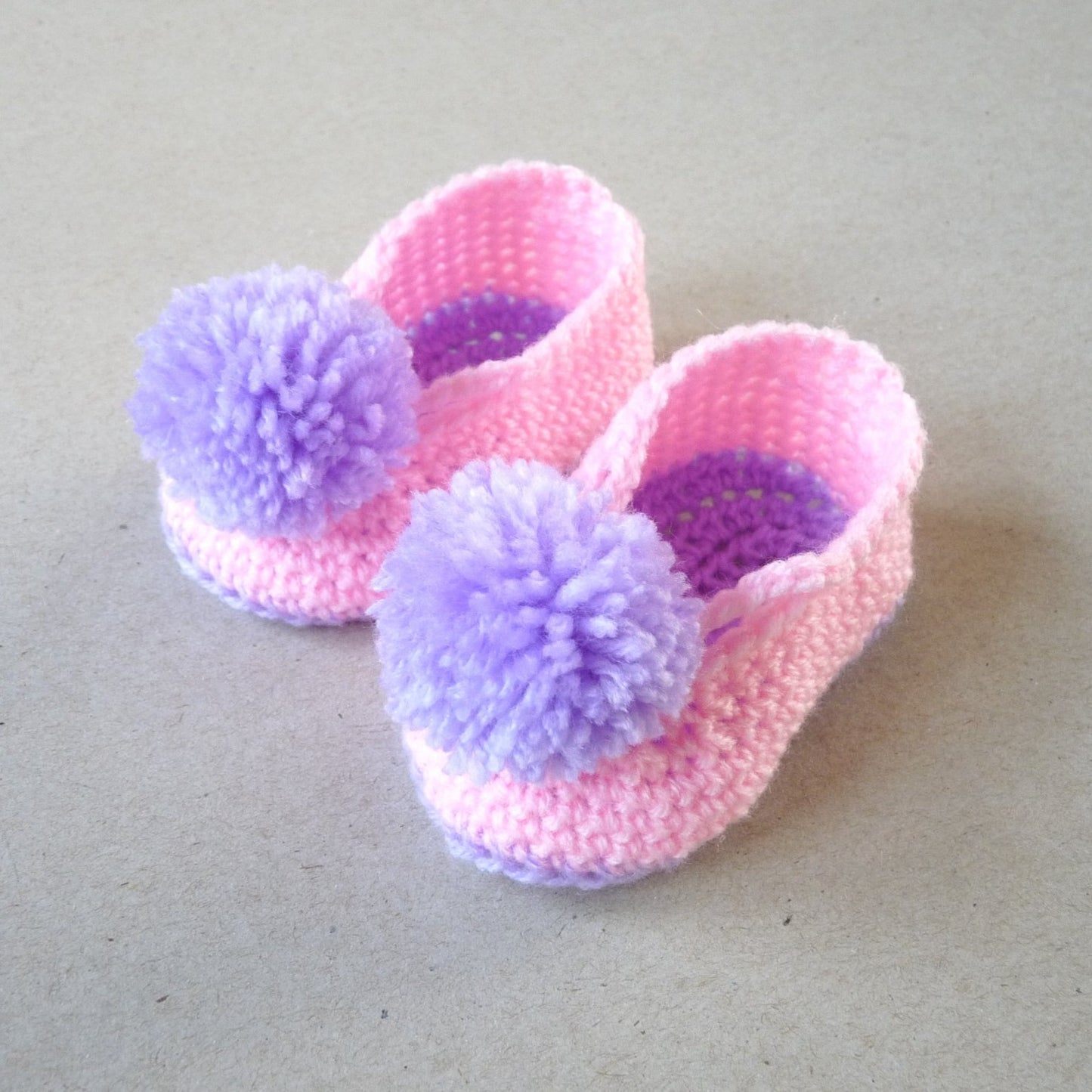 crochet baby shoes with pompoms for girls, purple and pink