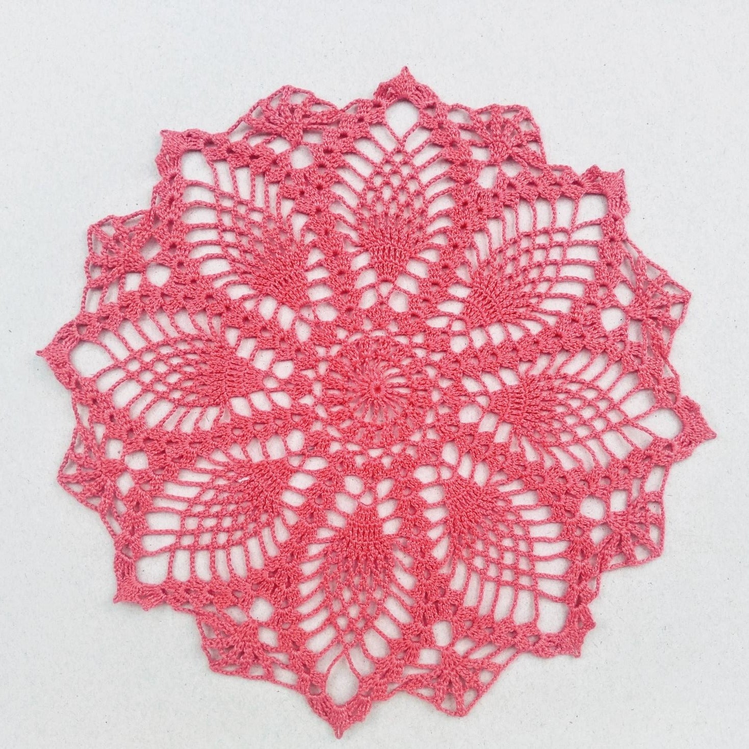 dark pink small round pineapple crochet lace doily