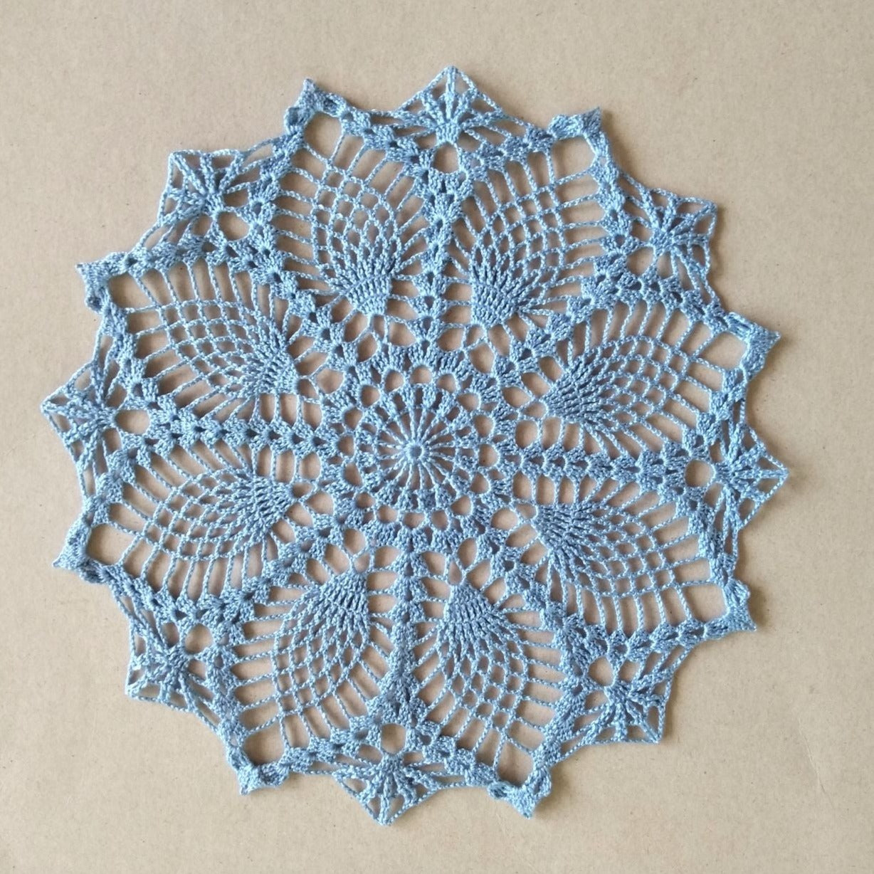 light blue small round pineapple crochet lace doily