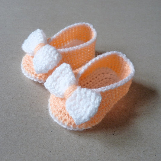 Light orange crochet baby shoes with bow