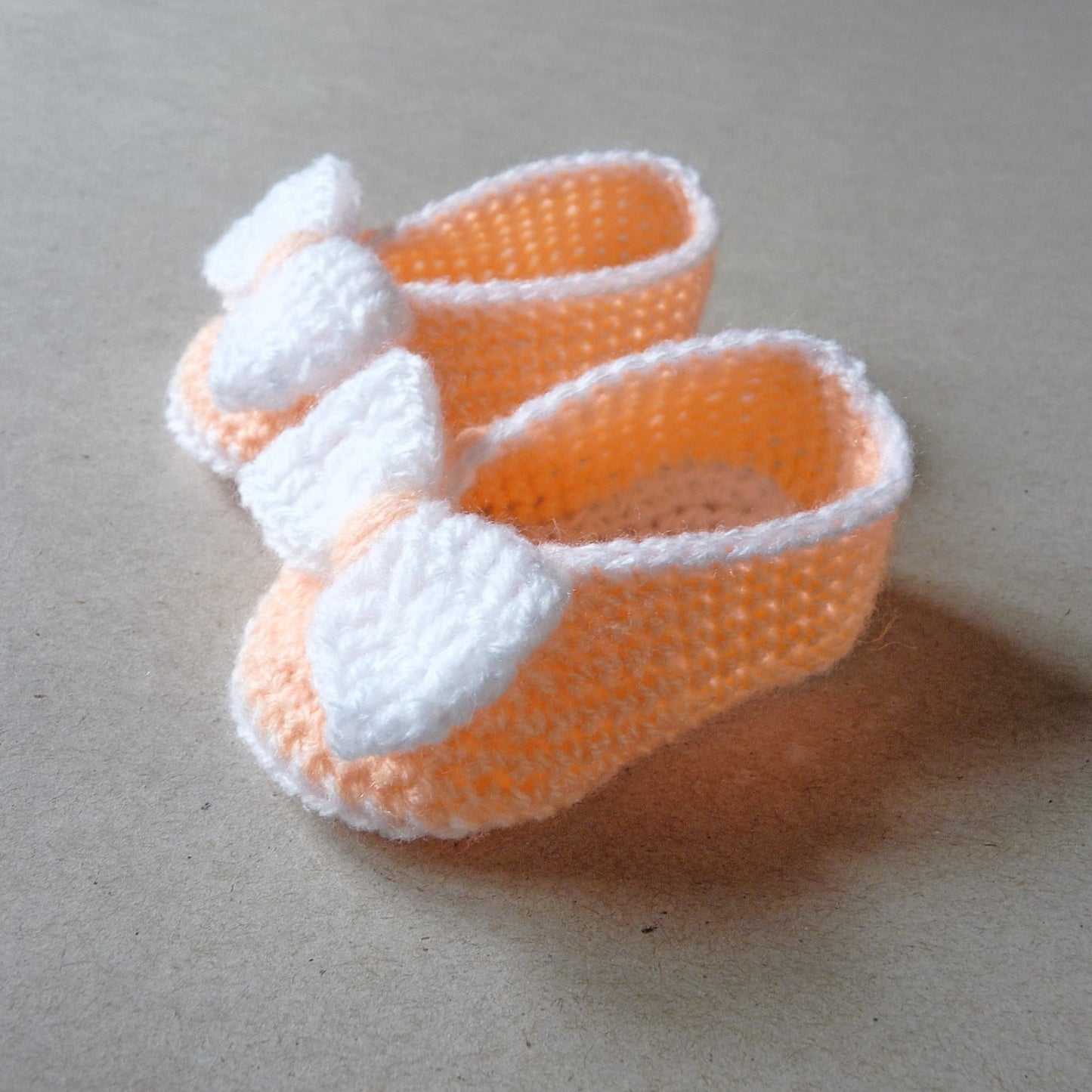 Light orange crochet baby shoes with bow