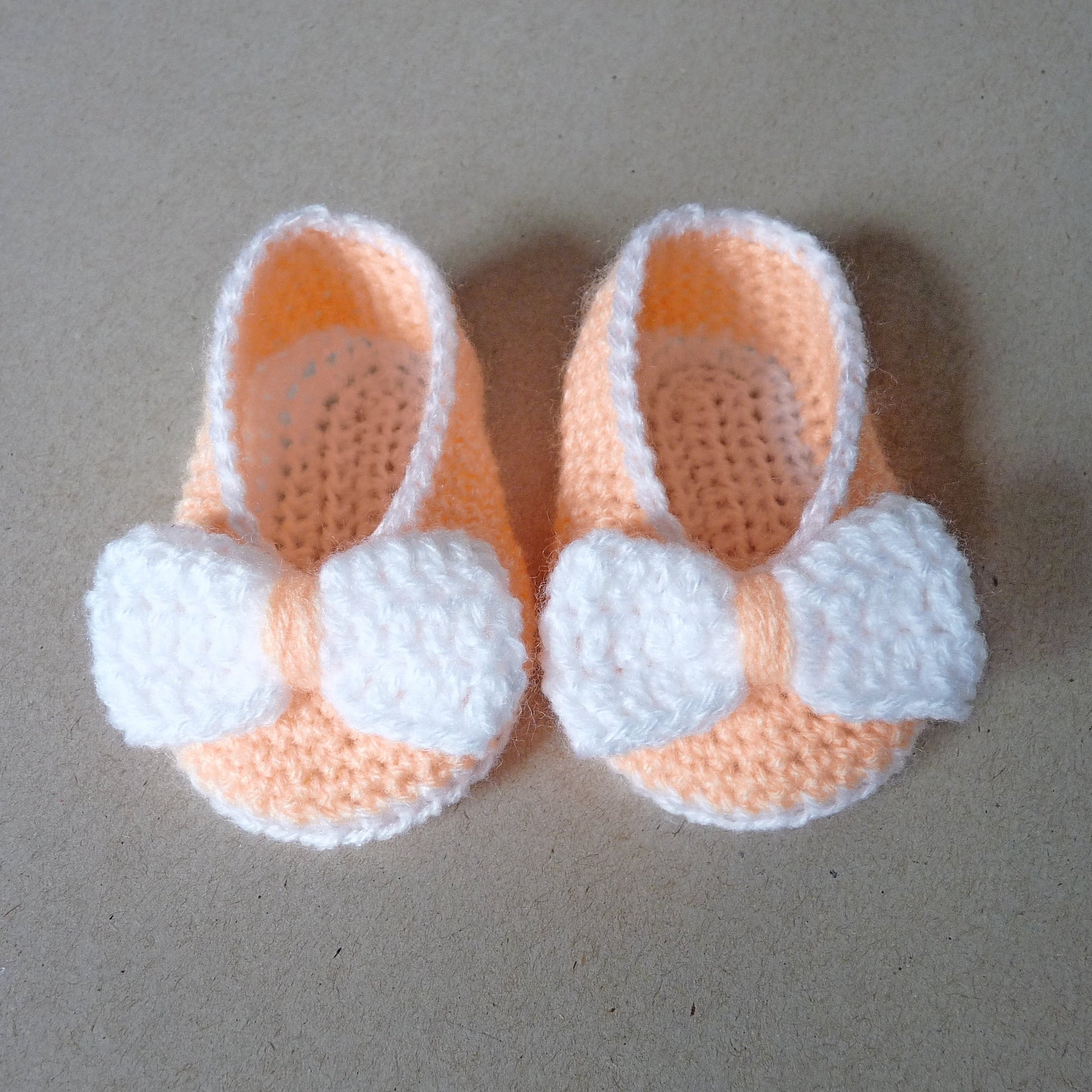 Light orange crochet baby shoes with bow