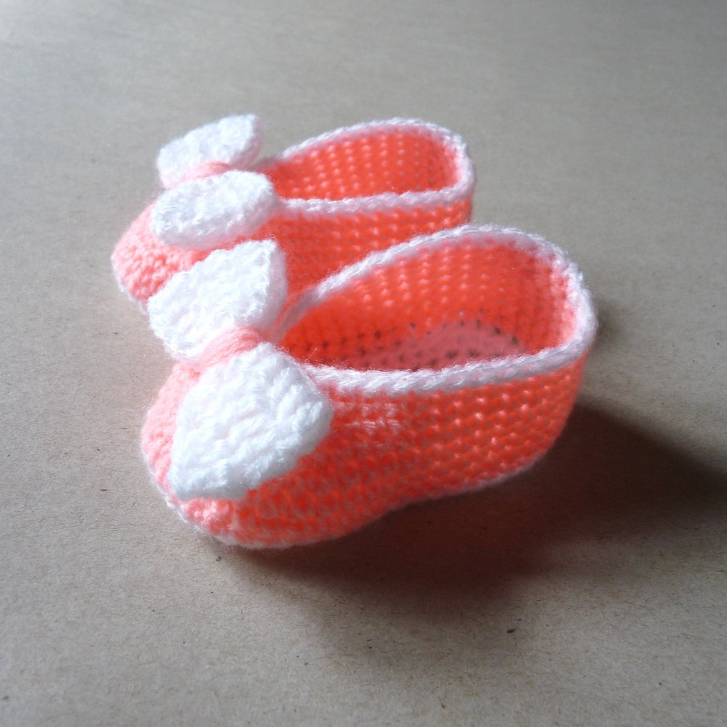 Peach crochet baby shoes with bow