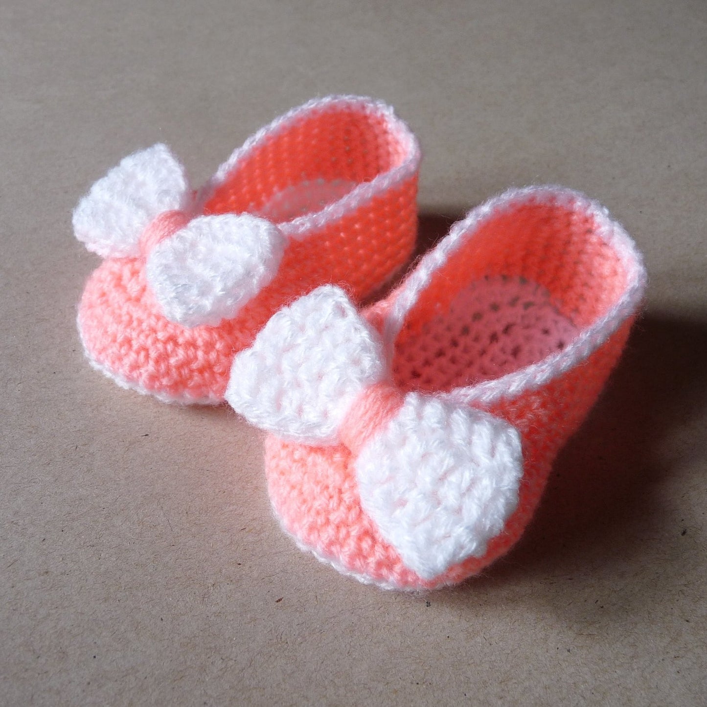 Peach crochet baby shoes with bow