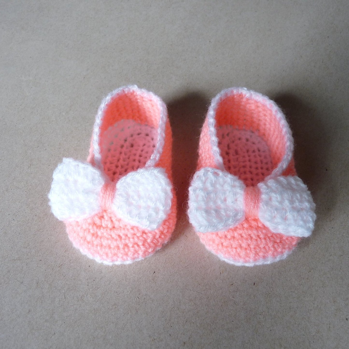 Peach crochet baby shoes with bow