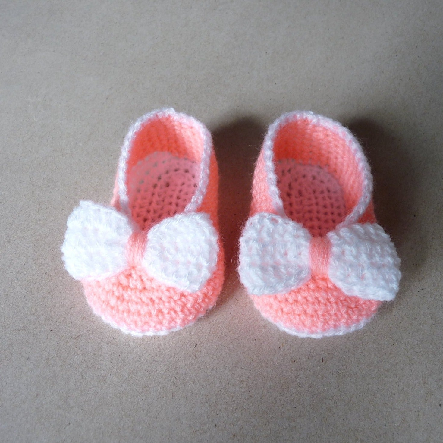 Peach crochet baby shoes with bow