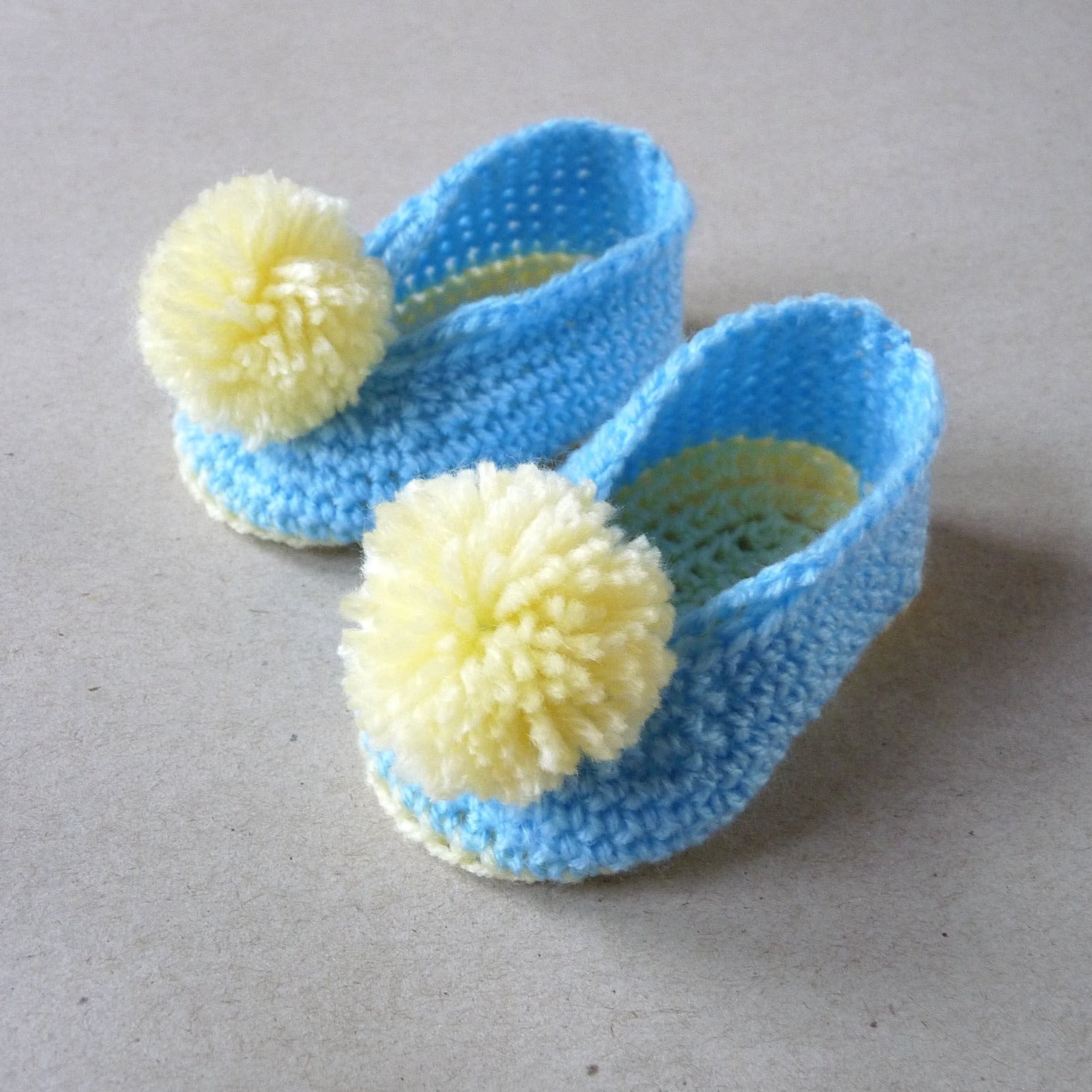 blue and yellow crochet baby shoes with pompoms, unisex baby shoes