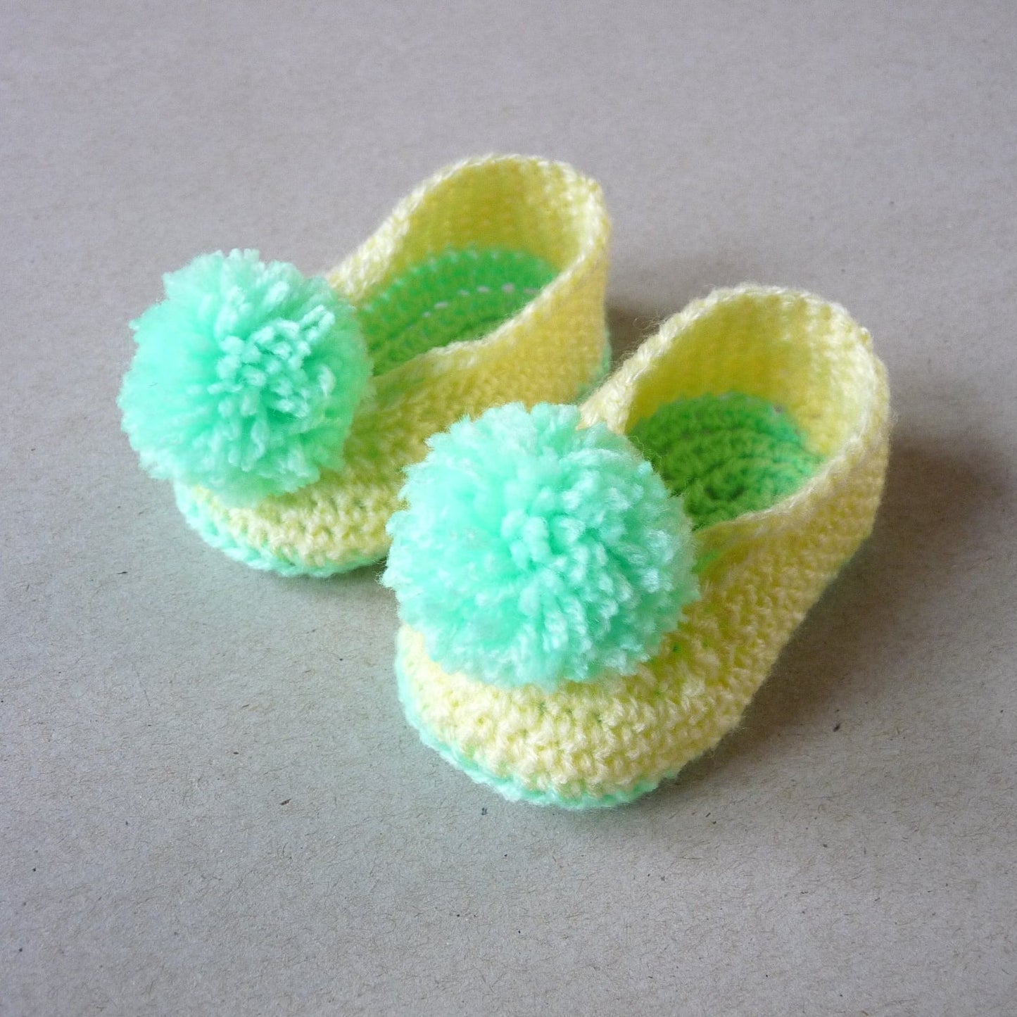 yellow and green crochet unisex baby shoes with pompoms