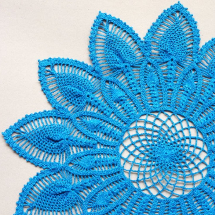 Large blue flower shaped crochet doily