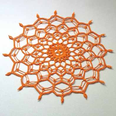 orange round hand crocheted doily