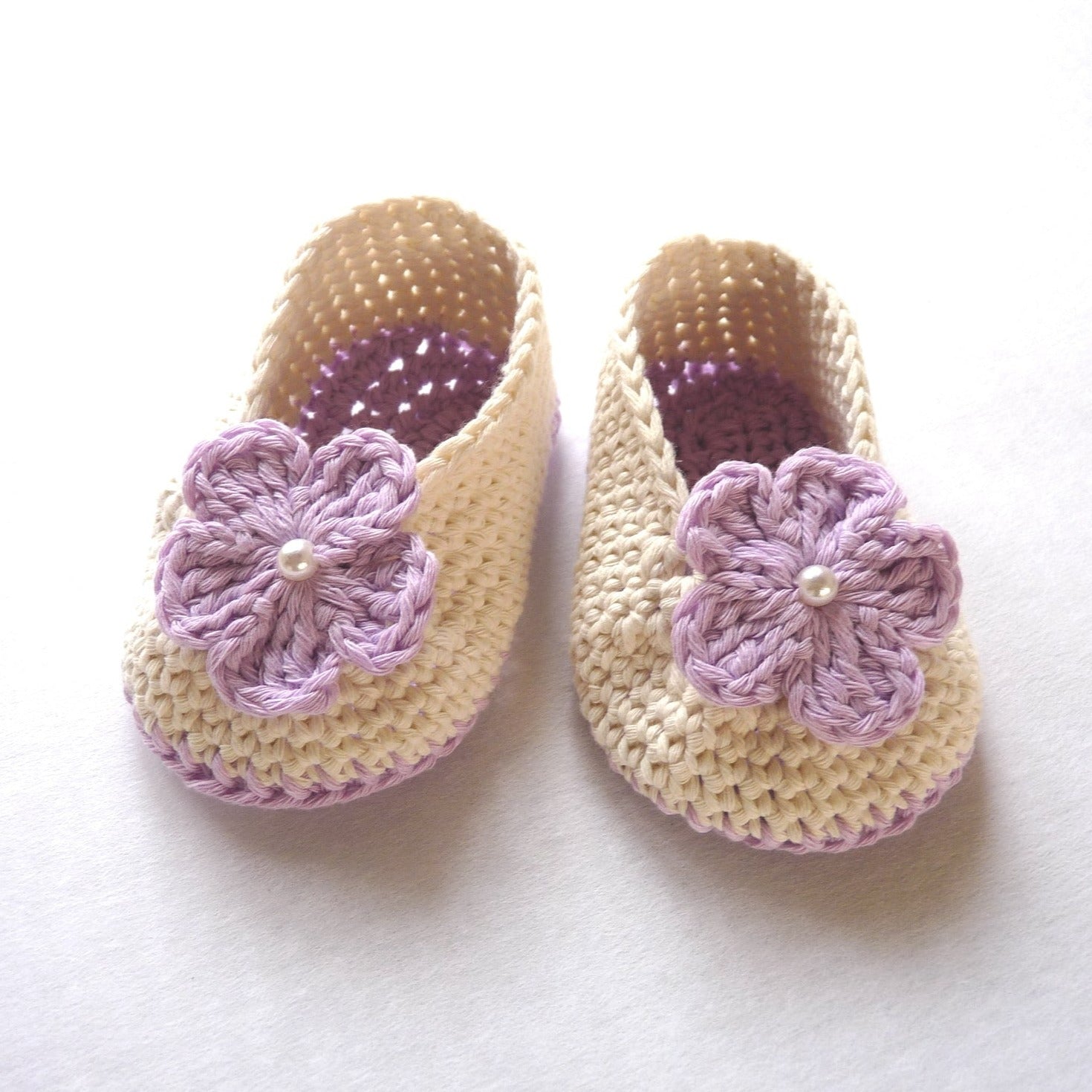 purple and off-white crochet baby shoes for girls