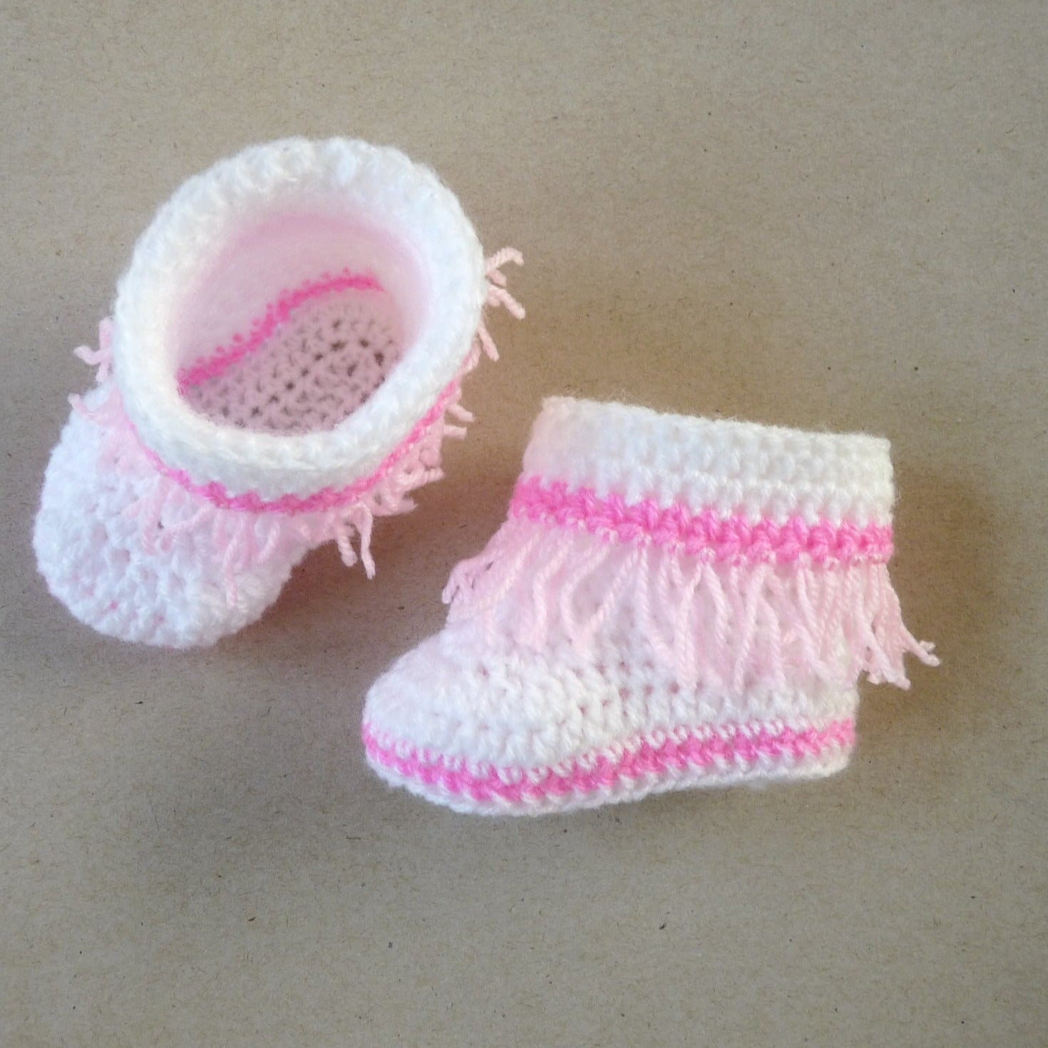 white and pink crochet baby moccasins