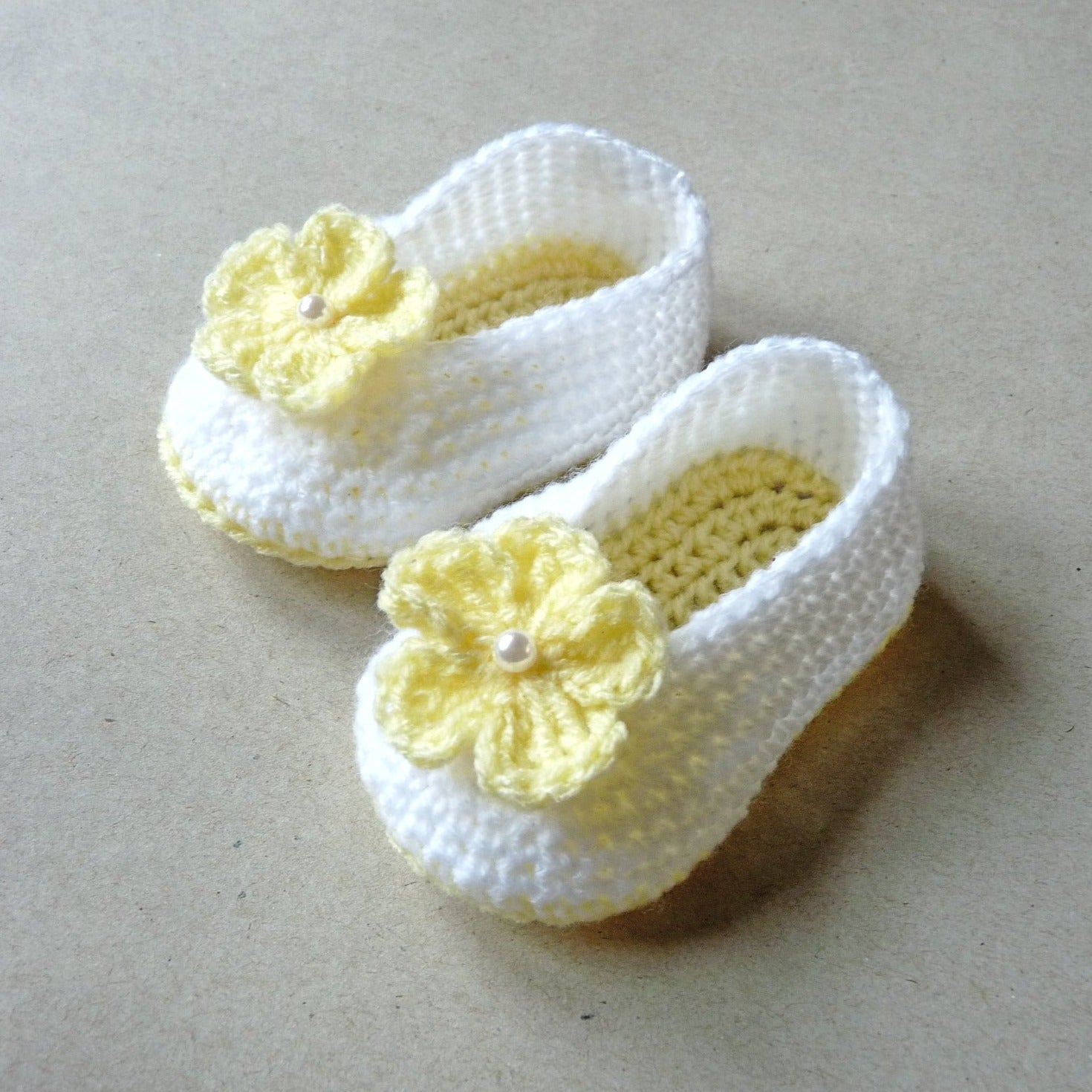 light yellow and white crochet baby shoes with flowers for girls