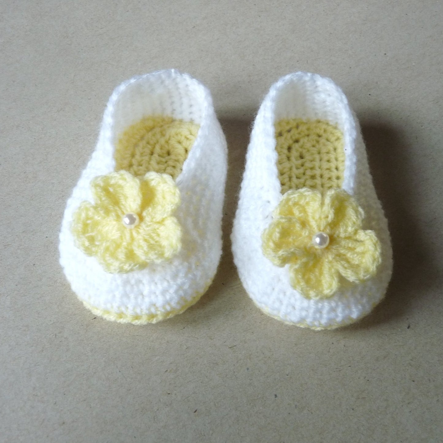 yellow and white crochet baby booties with flowers for girls