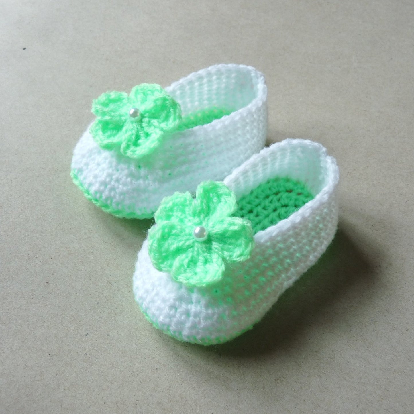 mint green and white crochet baby shoes with flowers