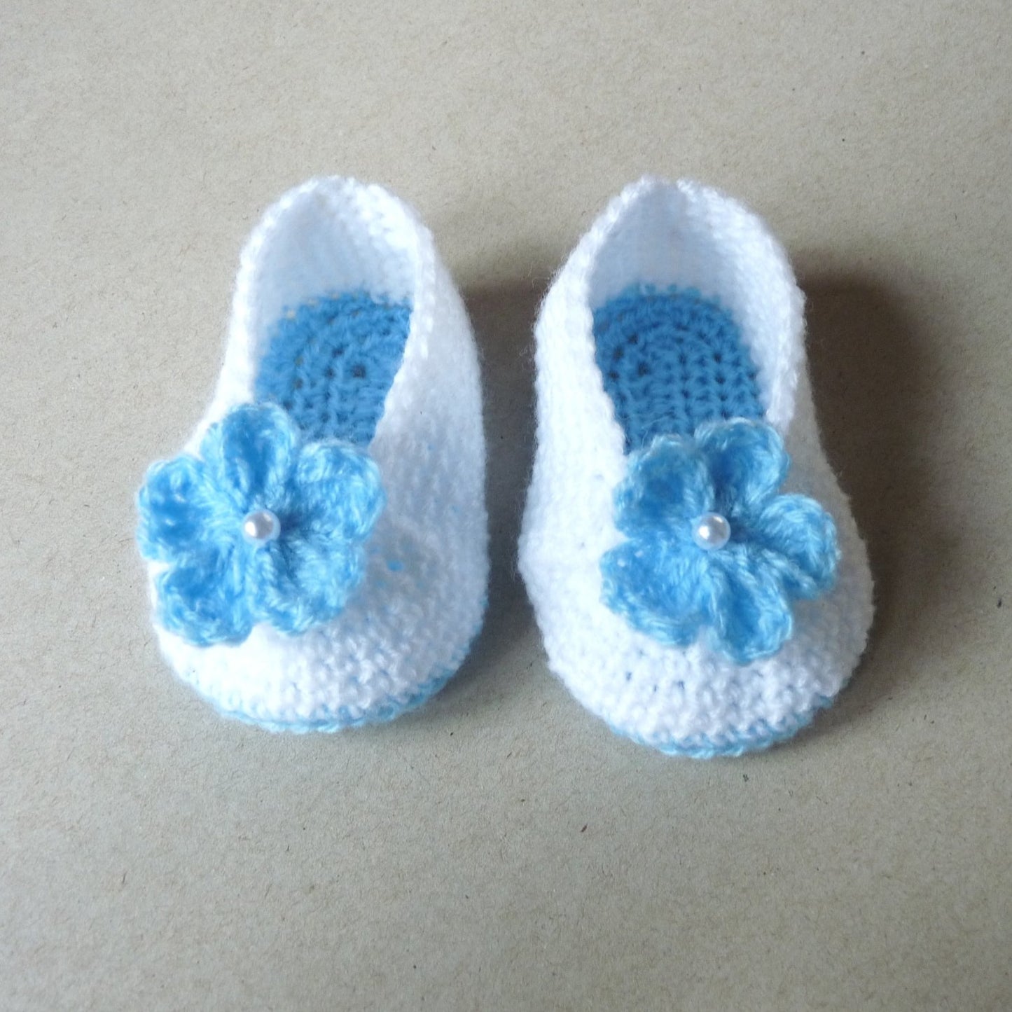 blue and white crochet baby booties with flowers for girls