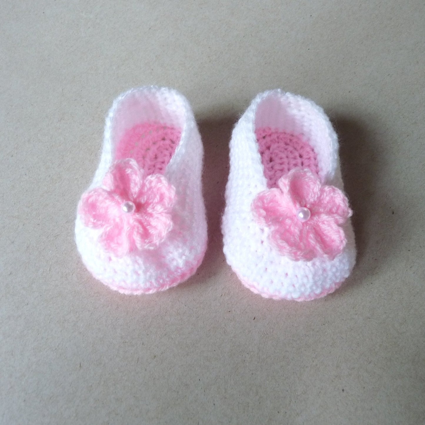 pink and white crochet baby booties with flowers for girls