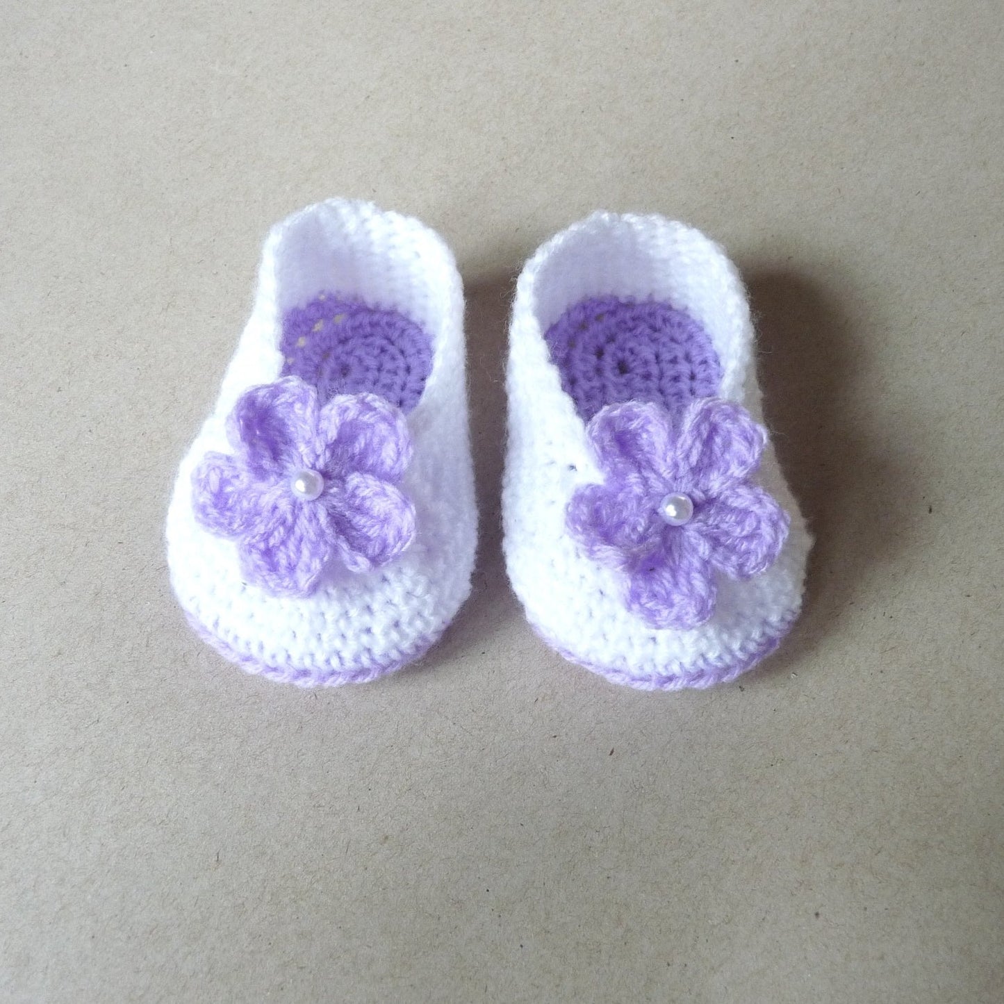 purple and white crochet baby booties with flowers for girls