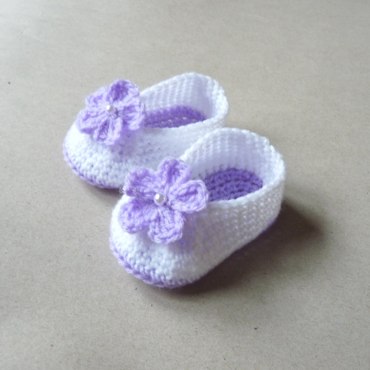 light purple and white crochet baby shoes with flowers for girls